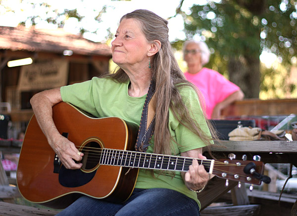 Julie Moon strummed  from the picnic tables before taking the stage at Pine Mountain Bluegrass Jamboree.